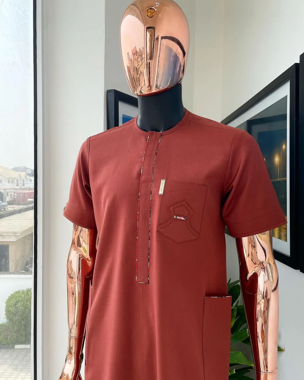 An Amber orange, paisley mountain top patch pocket detailing African traditional senator Kaftan native.