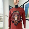 An Amber-orange piped neckline with a 3D lion king head patch stitched embroidery detailing African traditional senator kaftan native.
