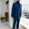 An Army green double-breasted peak lapel suit