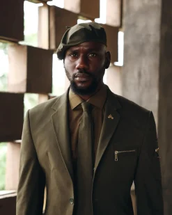 An Army Green Monochrome “Junta” Notch Lapel Suit With Patch Pocket Zip Detailing & Gurkha Pant Trousers.
