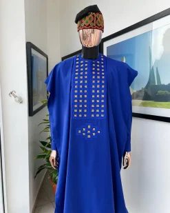 An Azure blue, connected square embroidery design with gold treading & matching Swarovski stone details agbada