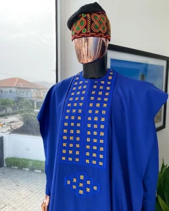 An Azure blue, connected square embroidery design with gold treading & matching Swarovski stone details agbada