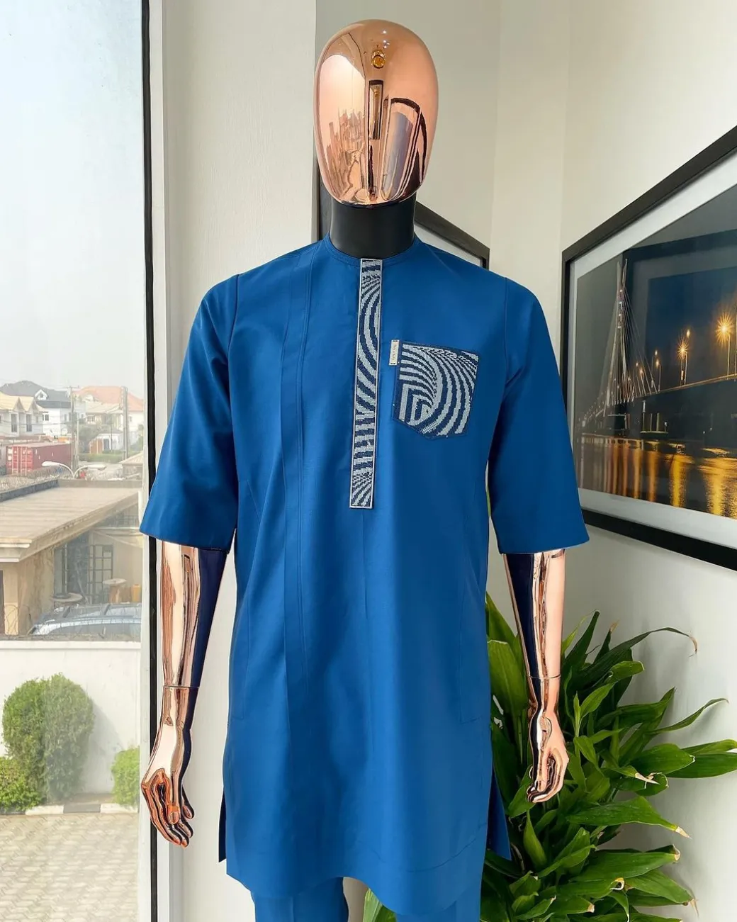 An azure blue, curly 3D embroidery flap and pocket detailing African traditional senator kaftan native