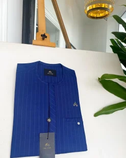 An Azure blue with Lapis blue stripe, Swarovski Button, strap shaped inner pocket details African traditional senator kaftan native.