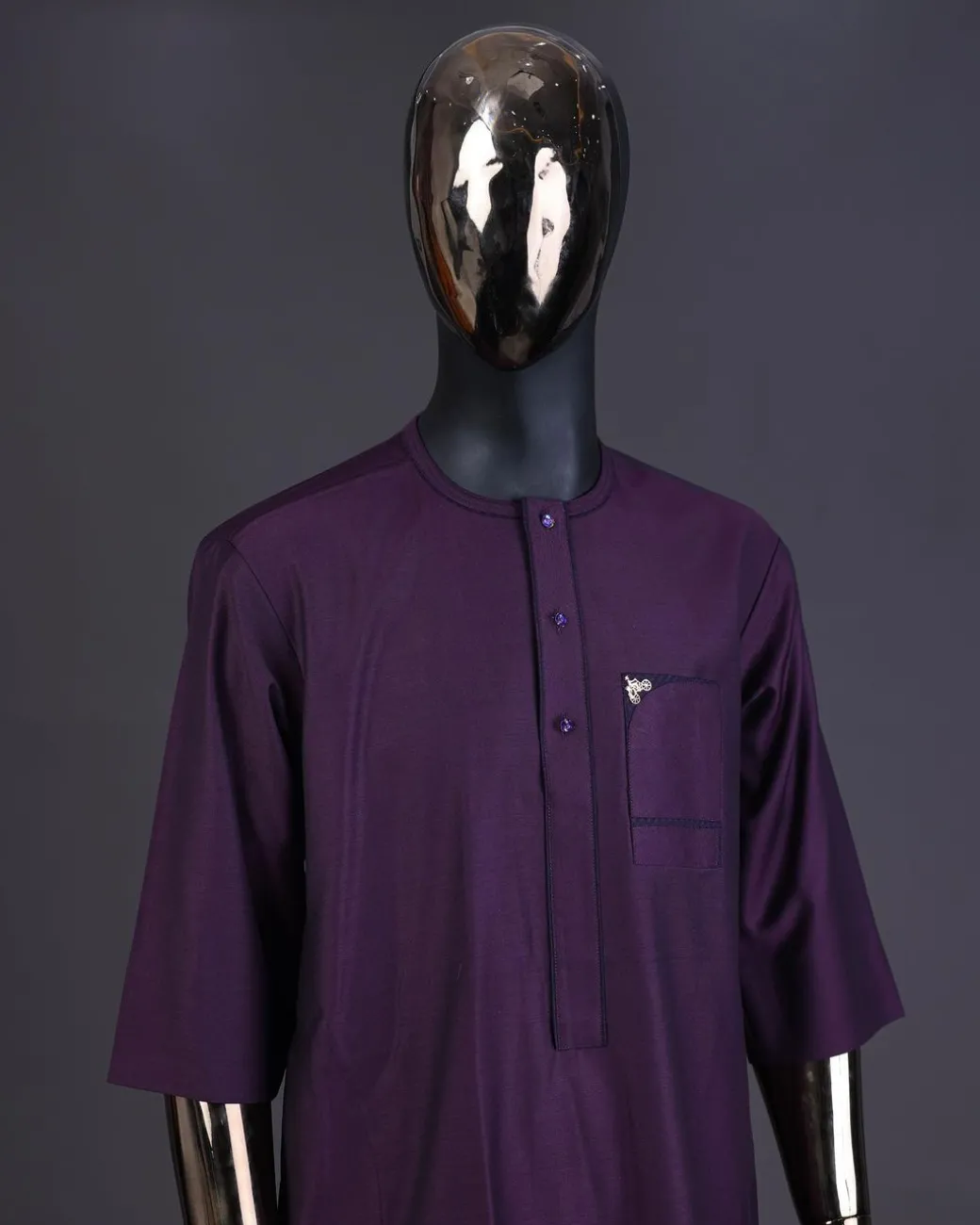 An eggplant purple front flap with matching Swarovski button detailing kaftan and Sokoto