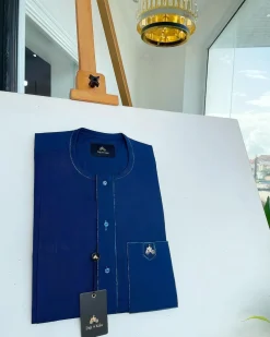 An Egyptian blue, front flap, patch pocket, matching Swarovski buttons, paisley detailing African senator kaftan native.