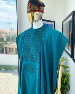 An emerald green, connected square embroidery design with matching green and red Swarovski stone details agbada
