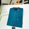 An emerald green with a Swarovski stone button and lower cylinder-shaped African Kaftan