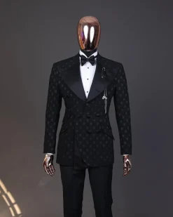 An Inverted “Pirate”, knitted, charcoal black with distributed square pattern jacquard peak lapel, 9 button tuxedo suit.
