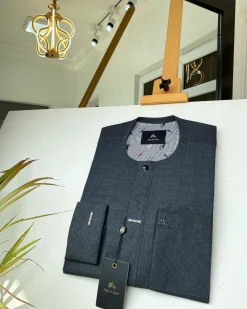 An Irish Grey African kaftan with a black Swarovski button and metal detailing