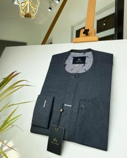 An Irish Grey African kaftan with a black Swarovski button and metal detailing