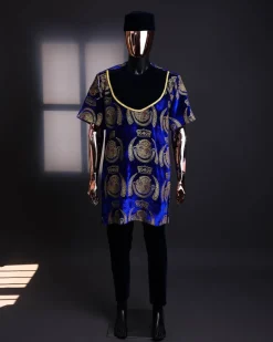 An “isiagu” gold, blue with matching fringe details, short sleeve, hat and velvet pant African traditional native.
