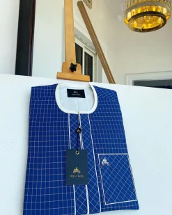 An ivory and blue check kaftan with an ivory-layered front section is a traditional African kaftan