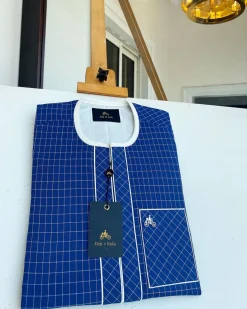 An ivory and blue check kaftan with an ivory-layered front section is a traditional African kaftan