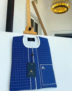 An ivory and blue check kaftan with an ivory-layered front section is a traditional African kaftan