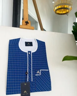 An ivory white and blue check, clear view transparent Swarovski buttons, front flap details African traditional senator kaftan native.