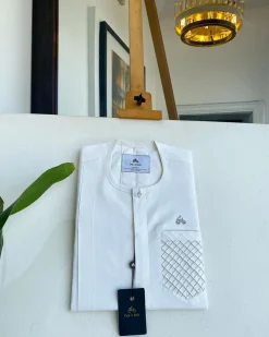 An Ivory White, clear view silver Swarovski buttons, ruffle pocket details, African traditional senator kaftan native.