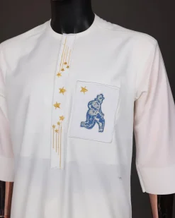 An Ivory white, dropping stars and bender knees metallic wire embroidery details agbada