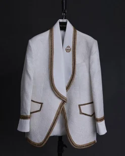 An ivory white floral Jacquard, gold trimmings, patch pocket shawl lapel tuxedo suit