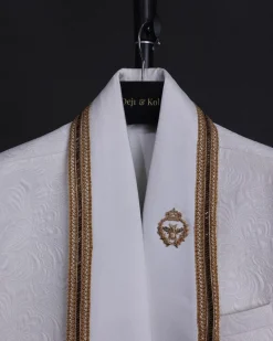 An ivory white floral Jacquard, gold trimmings, patch pocket shawl lapel tuxedo suit