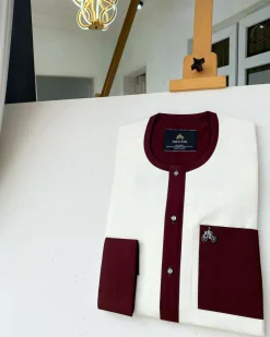 An Ivory white kaftan with a burgundy mix flap, pocket, and cuff design African Kaftan