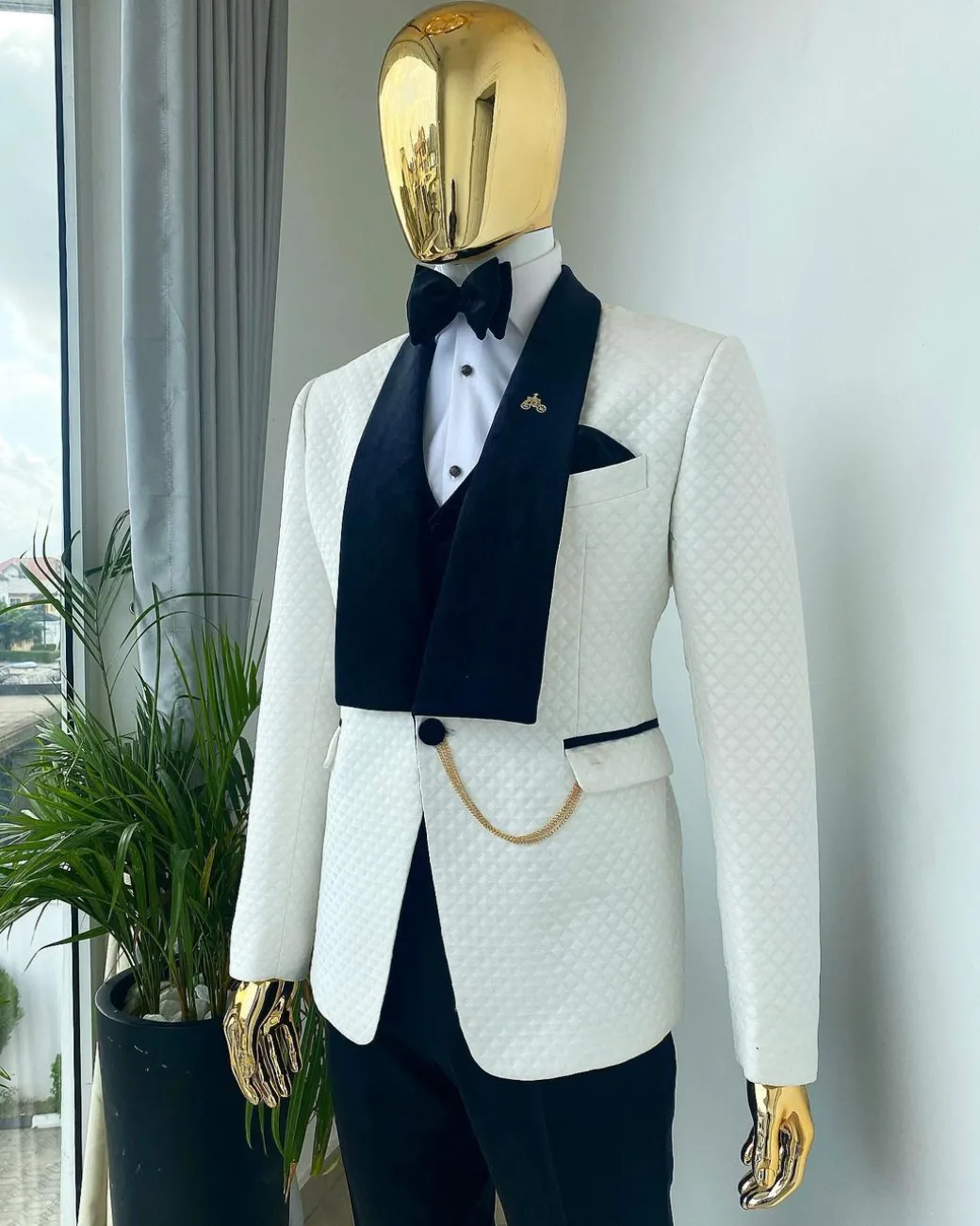 An Ivory white shawl lapel square pattern jacquard tuxedo suit.