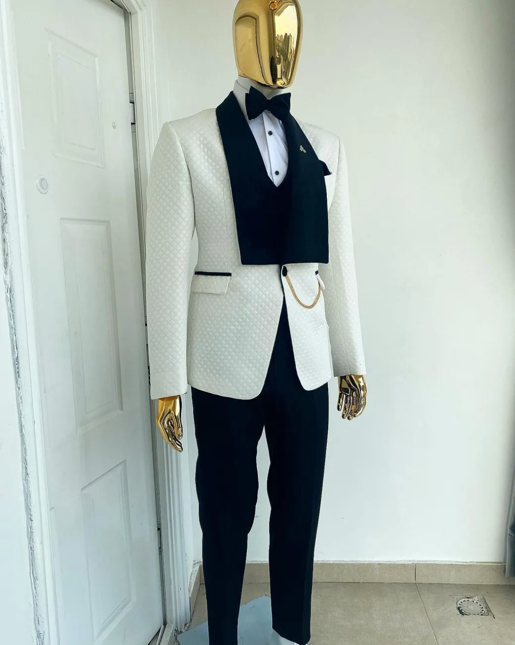An Ivory white shawl lapel square pattern jacquard tuxedo suit.