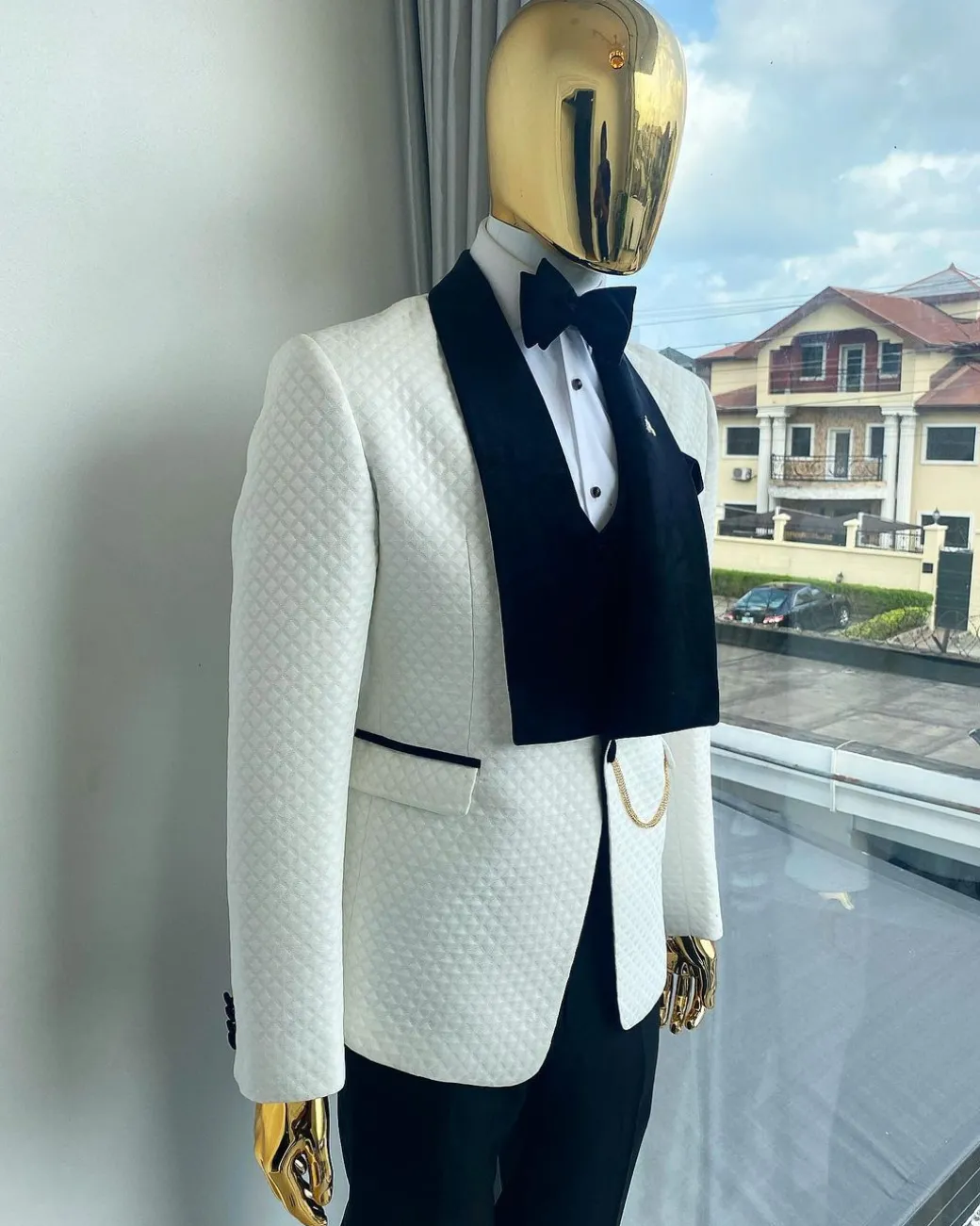 An Ivory white shawl lapel square pattern jacquard tuxedo suit.