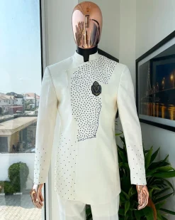 An ivory white, slide cut, navy blue dispersed safari suit with clustered Swarovski stone detailing