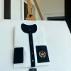 An Ivory white with a black flap, red detail button and royalty badge African Kaftan and Sokoto