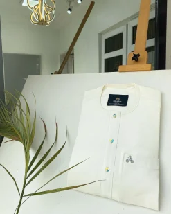An Ivory white with a matching rainbow-shaded glass button African Kaftan