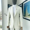 An Ivory white, x-large combat patch pocket, peak lapel suit