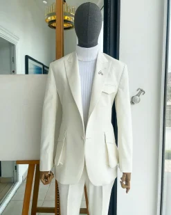 An Ivory white, x-large combat patch pocket, peak lapel suit