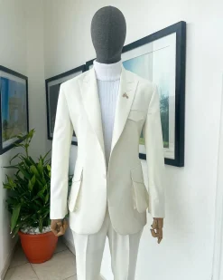 An Ivory white, x-large combat patch pocket, peak lapel suit