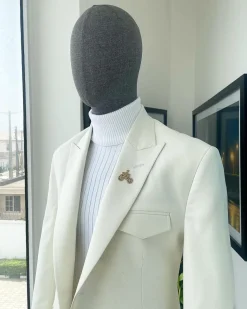An Ivory white, x-large combat patch pocket, peak lapel suit