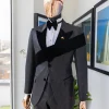 An “Octopus” black inverted square patterned jacquard tuxedo with left strap black velvet peak lapel suit
