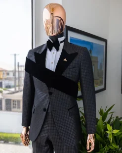 An “octopus” black inverted square patterned jacquard tuxedo with right strap black velvet peak lapel suit
