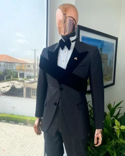 An “octopus” black inverted square patterned jacquard tuxedo with right strap black velvet peak lapel suit