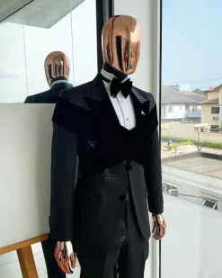 An “Octopus” black inverted square patterned metallic jacquard tuxedo with intersected black velvet peak lapel suit