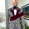 An “octopus” floral paisley tuxedo with left side strap mahogany red soaked Italian velvet peak lapel suit