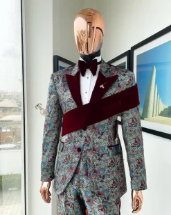 An “octopus” floral paisley tuxedo with left side strap mahogany red soaked Italian velvet peak lapel suit