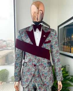 An “octopus” floral paisley tuxedo with right side strap mahogany red soaked Italian velvet peak lapel suit