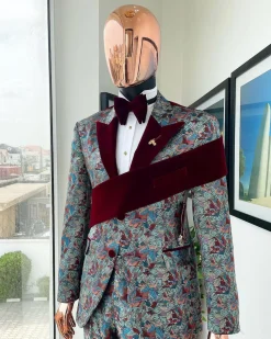 An “octopus” floral paisley tuxedo with left side strap mahogany red soaked Italian velvet peak lapel suit