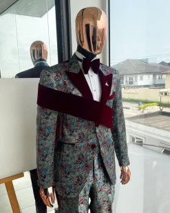 An “octopus” floral paisley tuxedo with right side strap mahogany red soaked Italian velvet peak lapel suit