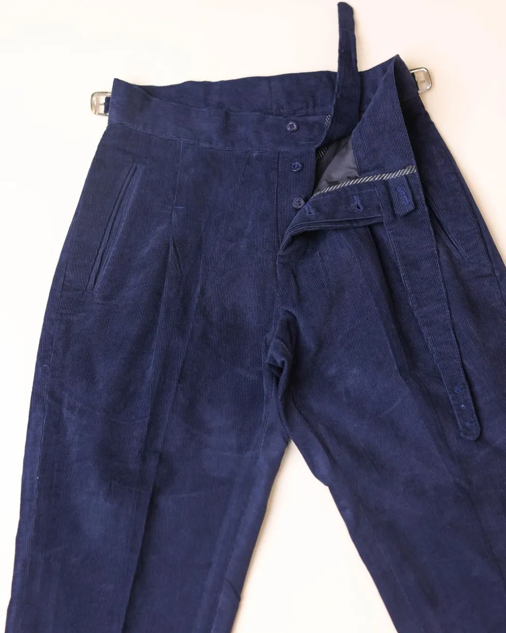 Gurkha trousers with pleats, double side strap buckles, slanted front welt pockets, and a back patch pocket.
