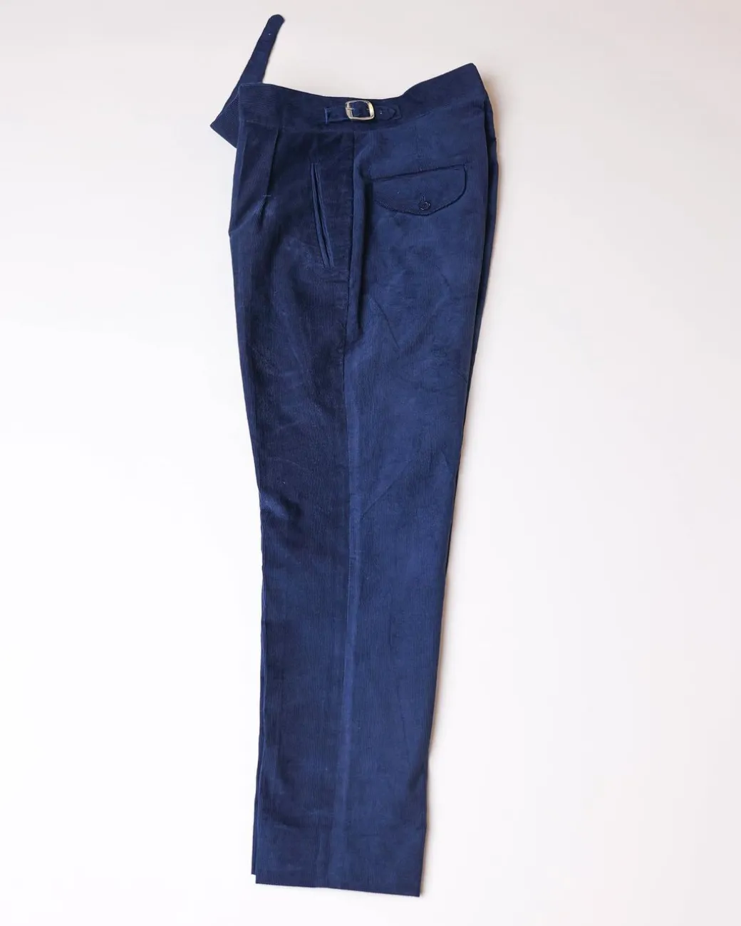 Gurkha trousers with pleats, double side strap buckles, slanted front welt pockets, and a back patch pocket.