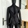 The Monochrome “okorodudu” mikado satin, charcoal black, big-notch lapel suit.