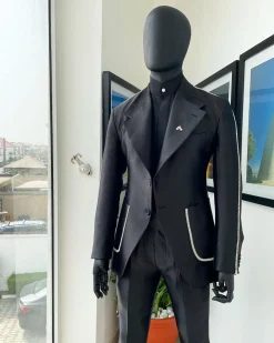 The Monochrome “okorodudu” mikado satin, charcoal black, big-notch lapel suit.