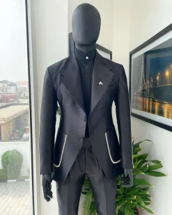 The Monochrome “okorodudu” mikado satin, charcoal black, big-notch lapel suit.