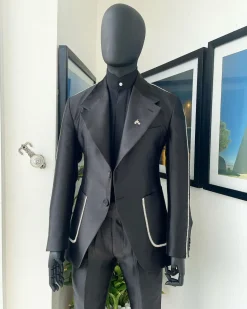 The Monochrome “okorodudu” mikado satin, charcoal black, big-notch lapel suit.
